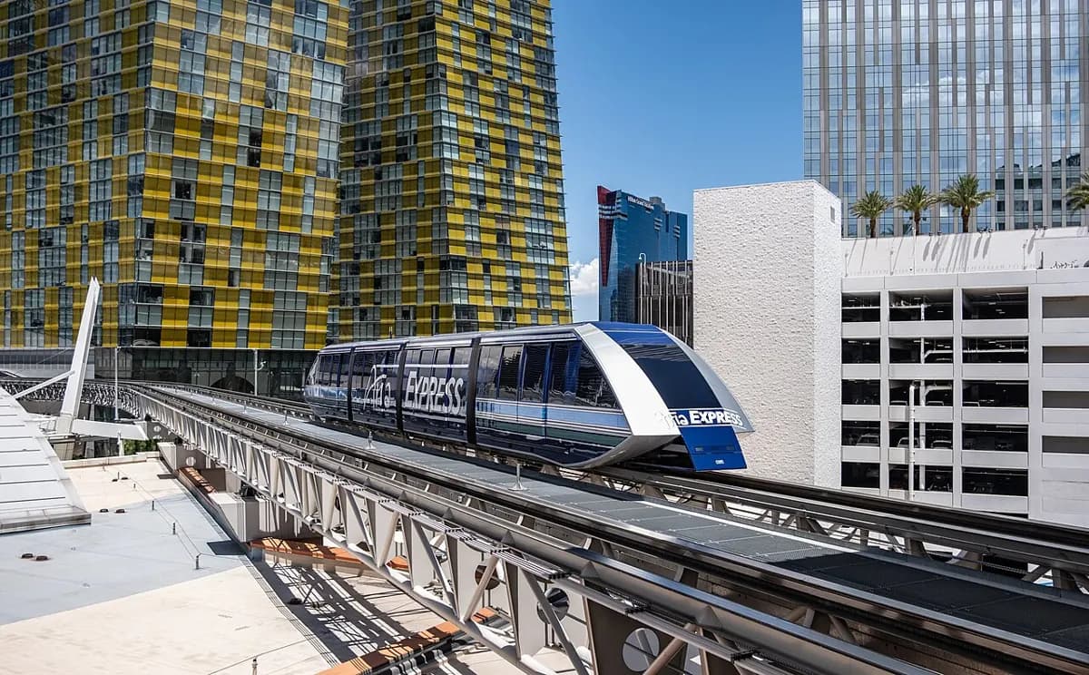 ARIA Express tram on its elevated track between resort buildings